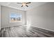 Bright bedroom featuring a large window and vinyl plank flooring at 245 Six Mile Creek Dr., Georgetown, SC 29440