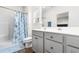 Clean bathroom with gray vanity, shower, and linen storage at 3009 South Bay St., Georgetown, SC 29440