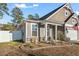 Craftsman style home with gray siding, landscaping, and a white fence at 3047 Honey Clover Ct., Longs, SC 29568