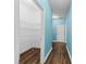 Hallway with light blue walls, wood floors, and a pantry at 3047 Honey Clover Ct., Longs, SC 29568