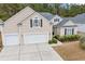 Two-story house with beige siding, a gray roof, and a two-car garage at 311 Highfield Loop, Myrtle Beach, SC 29579