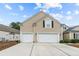 House exterior with two-car garage and neutral siding at 311 Highfield Loop, Myrtle Beach, SC 29579