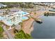 Aerial view of community pool, lazy river, playground, clubhouse, and lake access at 311 Highfield Loop, Myrtle Beach, SC 29579