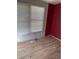 Small bedroom with red accent wall and wood flooring at 3586 Cluster Ln., Myrtle Beach, SC 29579