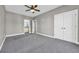 Spacious bedroom with grey carpet, ceiling fan and ensuite bathroom at 369 Saint Julian Ln., Myrtle Beach, SC 29579