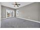 Bright bedroom with grey carpet, ceiling fan and access to balcony at 369 Saint Julian Ln., Myrtle Beach, SC 29579