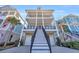 Curved staircase leading to the entrance of a charming three-story home at 369 Saint Julian Ln., Myrtle Beach, SC 29579