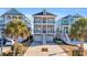 Three-story home with gray siding, red door, and two-car garage at 369 Saint Julian Ln., Myrtle Beach, SC 29579