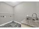 Convenient laundry room with utility sink and ample shelving at 369 Saint Julian Ln., Myrtle Beach, SC 29579