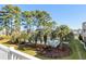 Inviting community pool surrounded by lush landscaping at 3700 Golf Colony Lane # 24B, Little River, SC 29566