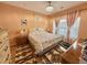 Main bedroom with a floral comforter and hardwood floors at 3951 Gladiola Ct. # 204, Myrtle Beach, SC 29588