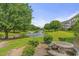 Serene pond with fountain, landscaping, and a stone table perfect for relaxing at 3951 Gladiola Ct. # 204, Myrtle Beach, SC 29588