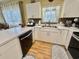 White kitchen with corner sink and dishwasher at 3951 Gladiola Ct. # 204, Myrtle Beach, SC 29588