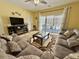 Living room with sectional sofa and access to balcony at 3951 Gladiola Ct. # 204, Myrtle Beach, SC 29588