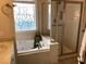Bathroom includes a bathtub, a window with decorative glass, and a glass shower at 41 Federation Loop, Pawleys Island, SC 29585