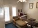 Sitting area with chaise lounge and wicker chair is well-lit with French doors and a ceiling fan at 41 Federation Loop, Pawleys Island, SC 29585