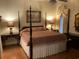 Elegant Primary bedroom with a four-poster bed and hardwood floors at 41 Federation Loop, Pawleys Island, SC 29585