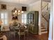 Charming dining area featuring a glass table, ornate chairs, and a classic hutch alongside the staircase at 41 Federation Loop, Pawleys Island, SC 29585