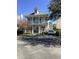 Elegant two-story house with double porches, a manicured lawn, and a driveway with parking for a car at 41 Federation Loop, Pawleys Island, SC 29585