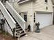 Exterior view of home, showcasing staircase leading to second story, garage and manicured landscaping at 41 Federation Loop, Pawleys Island, SC 29585
