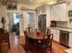 Eat-in kitchen featuring white cabinetry, stainless steel appliances, and a cozy breakfast nook with a wooden table at 41 Federation Loop, Pawleys Island, SC 29585