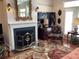 Cozy living area with a fireplace, a decorative mirror, and floral armchairs set on a colorful rug at 41 Federation Loop, Pawleys Island, SC 29585