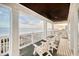 Oceanfront balcony with white chairs and railings at 4208 N Ocean Blvd., North Myrtle Beach, SC 29582