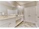 Bathroom with double vanity, white cabinets, and granite countertop at 4208 N Ocean Blvd., North Myrtle Beach, SC 29582