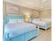 Bedroom with twin beds, light blue frames, and coastal decor at 4208 N Ocean Blvd., North Myrtle Beach, SC 29582