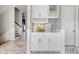 White built-in wet bar with quartz countertop and glass-front cabinets at 4208 N Ocean Blvd., North Myrtle Beach, SC 29582