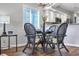 Bright dining area with glass-top table and wicker chairs at 4413 East Port Blvd. # F-6, Little River, SC 29566