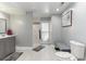 Modern bathroom with gray walls, marble shower, and gray vanity at 4705 Harness Ln., Murrells Inlet, SC 29576