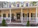 House exterior with welcoming front porch and brick steps at 4705 Harness Ln., Murrells Inlet, SC 29576