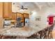 Granite kitchen island with seating overlooking the Gathering room at 4705 Harness Ln., Murrells Inlet, SC 29576