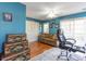 Home office with blue walls, ceiling fan, and built-in shelving at 4705 Harness Ln., Murrells Inlet, SC 29576