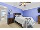 A cozy bedroom features a ceiling fan, wooden furniture, and soft carpet flooring at 4821 Southgate Pkwy., Myrtle Beach, SC 29579