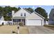 Beige house with a white garage door and landscaping at 4821 Southgate Pkwy., Myrtle Beach, SC 29579