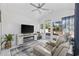Bright living room features a ceiling fan, fireplace, tv, and sliding glass doors to the exterior at 4821 Southgate Pkwy., Myrtle Beach, SC 29579