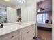 Bright bathroom with white vanity, large mirror, and view of bedroom at 49 Daniel Morrall Ln., Georgetown, SC 29440