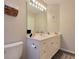 Clean bathroom with white vanity, large mirror, and toilet at 49 Daniel Morrall Ln., Georgetown, SC 29440