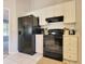 Modern kitchen with black refrigerator and stove at 49 Daniel Morrall Ln., Georgetown, SC 29440