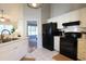 Kitchen boasts white cabinets, black appliances, and a double sink at 49 Daniel Morrall Ln., Georgetown, SC 29440