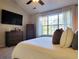 Spacious main bedroom with large window, dresser, and TV at 49 Daniel Morrall Ln., Georgetown, SC 29440