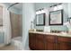 Bathroom with a tub, double vanity, and granite countertop at 4918 Old Appleton Way, North Myrtle Beach, SC 29582