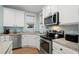 Modern kitchen featuring stainless steel appliances and white cabinets at 4918 Old Appleton Way, North Myrtle Beach, SC 29582