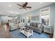 Spacious living room with gray couch and light blue walls at 4918 Old Appleton Way, North Myrtle Beach, SC 29582