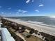 Expansive ocean view of sandy beach, gentle waves, blue skies and scattered clouds at 504 N Ocean Blvd. # 1003, Myrtle Beach, SC 29577