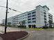 Homewood Suites building featuring bay view parking with palm tree landscaping and shade at 504 N Ocean Blvd. # 1003, Myrtle Beach, SC 29577