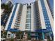 A striking view of a white high-rise condo building featuring modern architectural elements and multiple balconies at 504 N Ocean Blvd. # 1003, Myrtle Beach, SC 29577