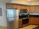 A well-equipped kitchen featuring stainless steel appliances, including a refrigerator, oven, and microwave at 504 N Ocean Blvd. # 1003, Myrtle Beach, SC 29577